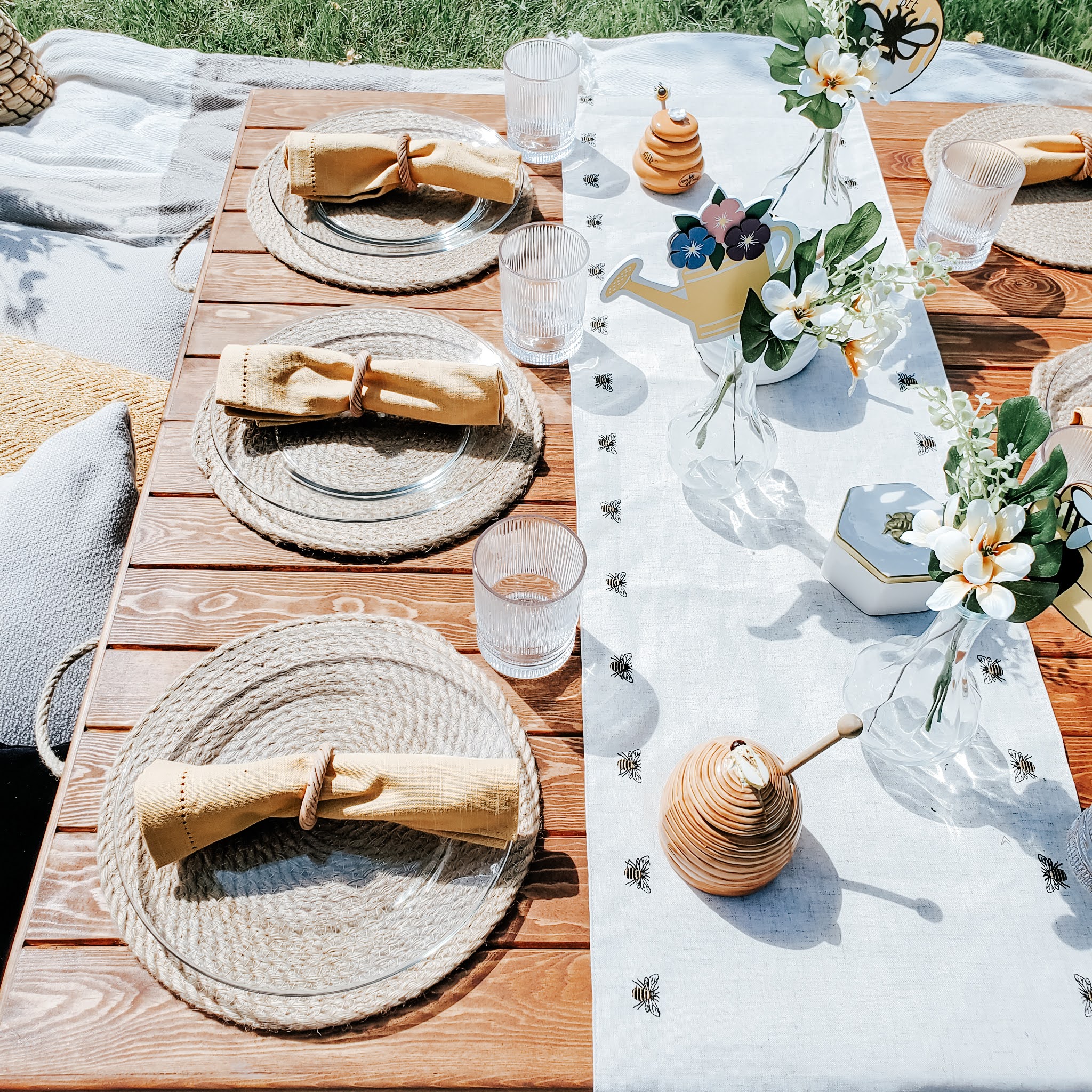 picnic table setting, yellow napkin, embroidered bee